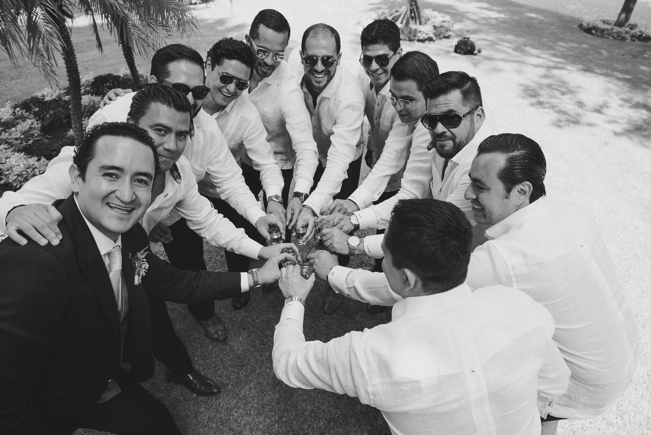 Novios y sus amigos brindando con un shot