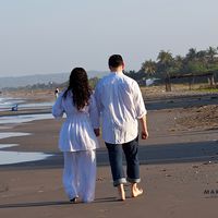 Caminar en la orilla del mar, tomados de la mano