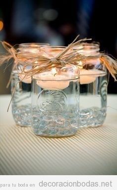 Bote de cristal con vela flotante