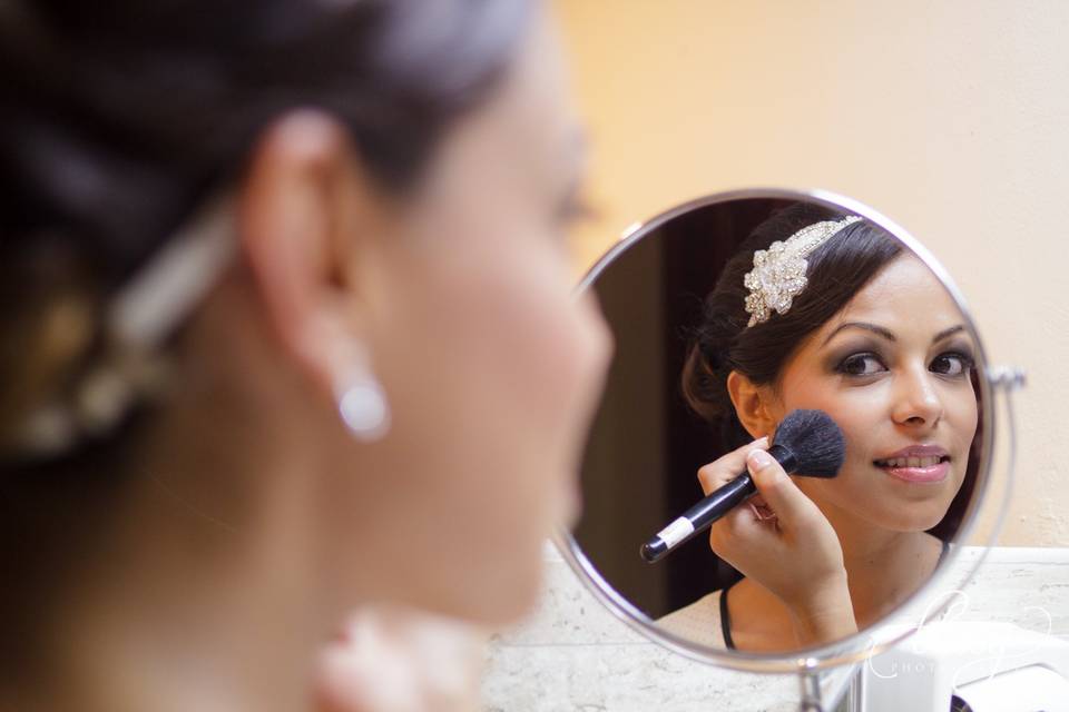 Bride at mirror getting ready