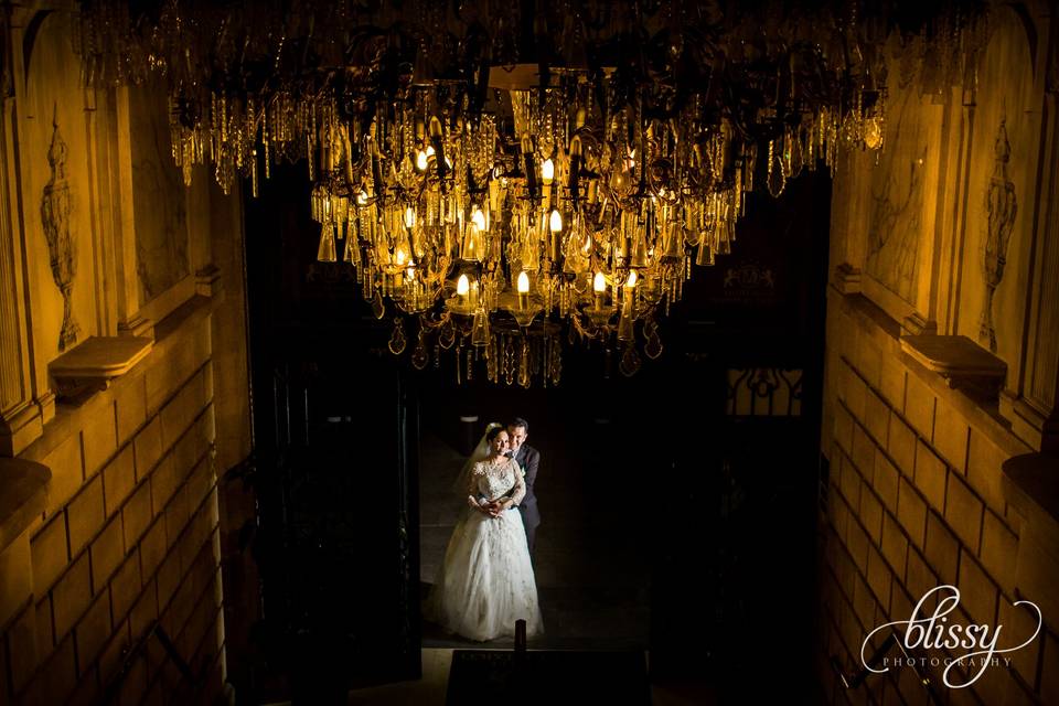 Bride & Groom under chandelier