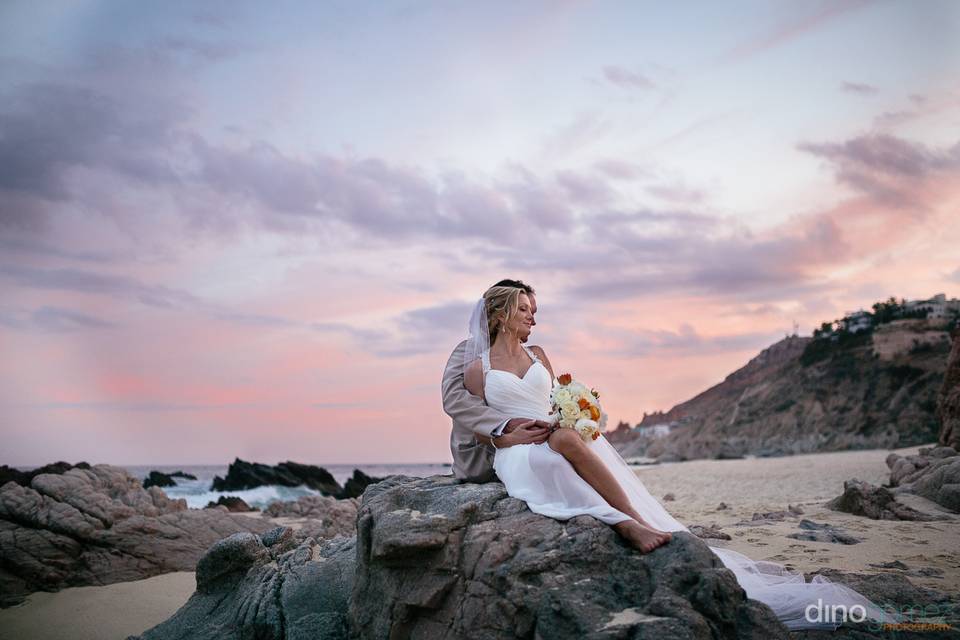 Novios en la playa con atardecer