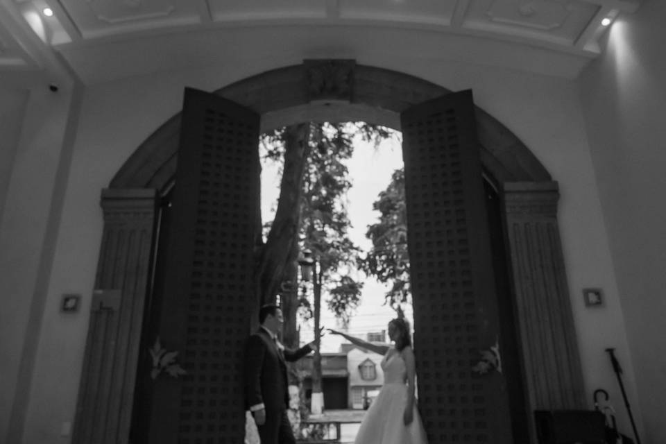 Novios recargados en unas puertas abiertas