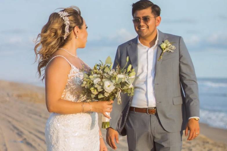 Pareja posando y sonriendo en la playa
