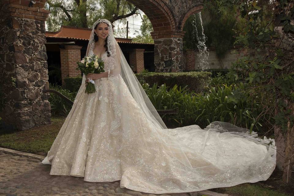 Novia con un vestido corte princesa sosteniendo su ramo blanco