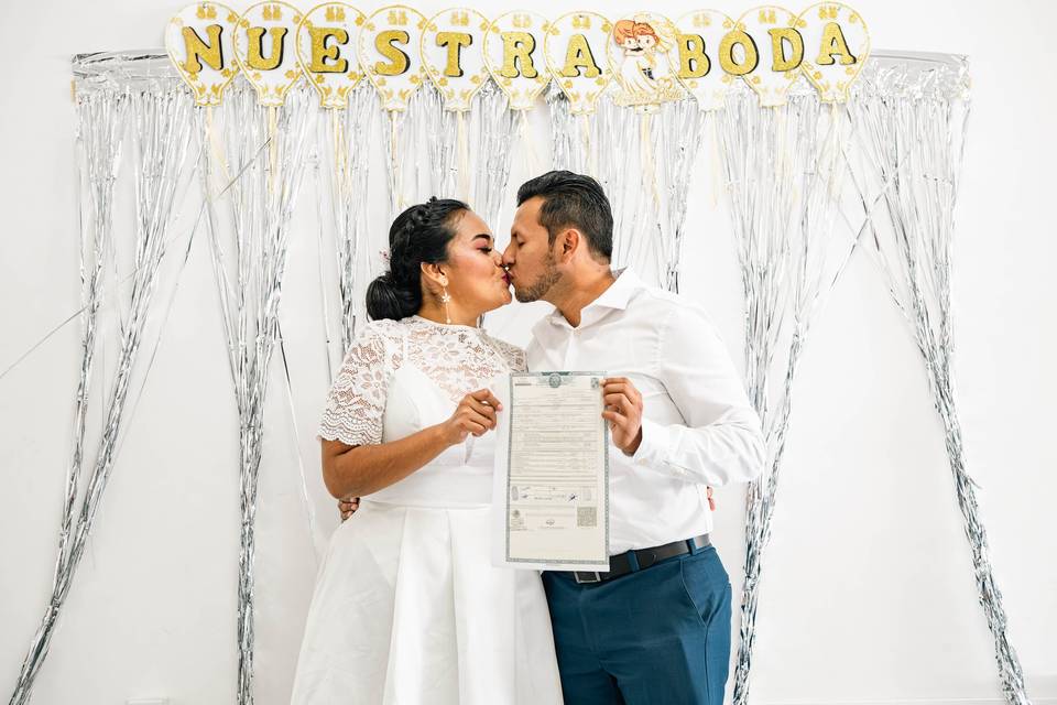 Pareja enseñando su acta de matrimonio