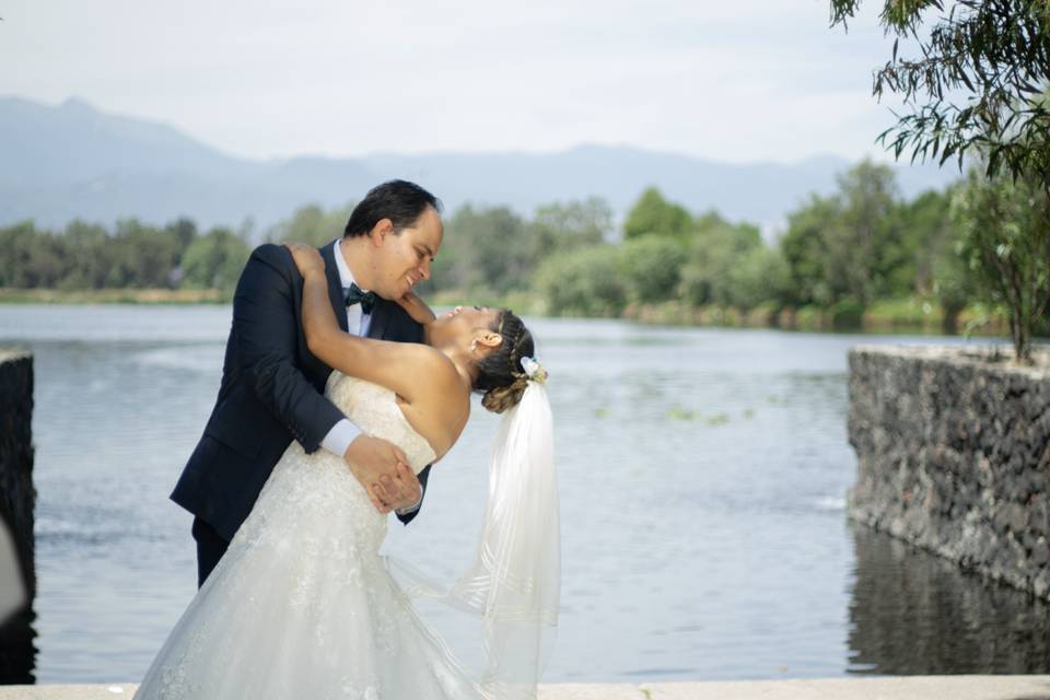 Pareja besándose frente a un lago