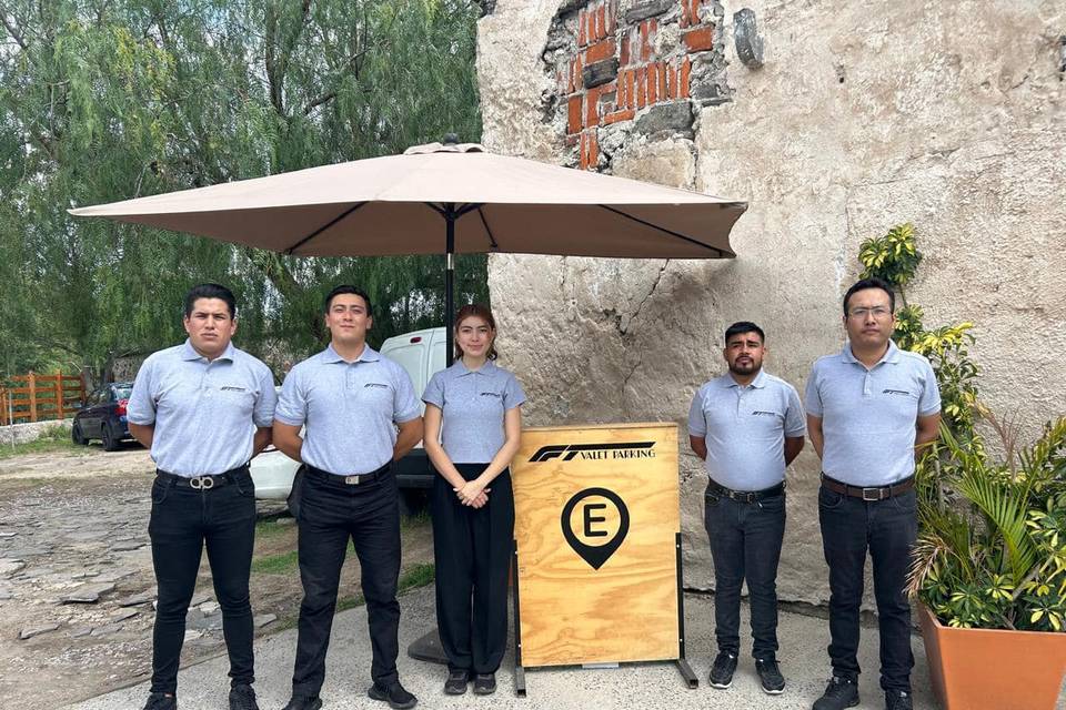 Equipo uniformado de valet parking en jardín